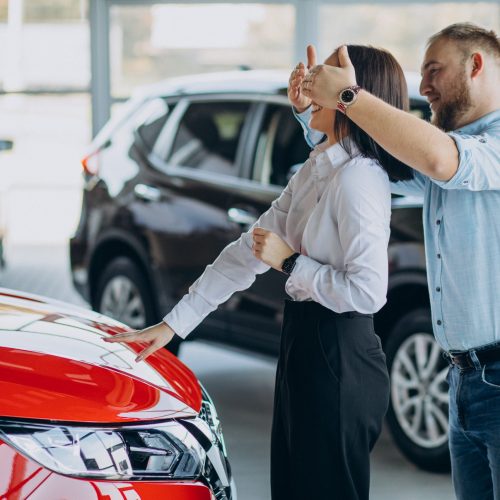 Young couple buying a new car